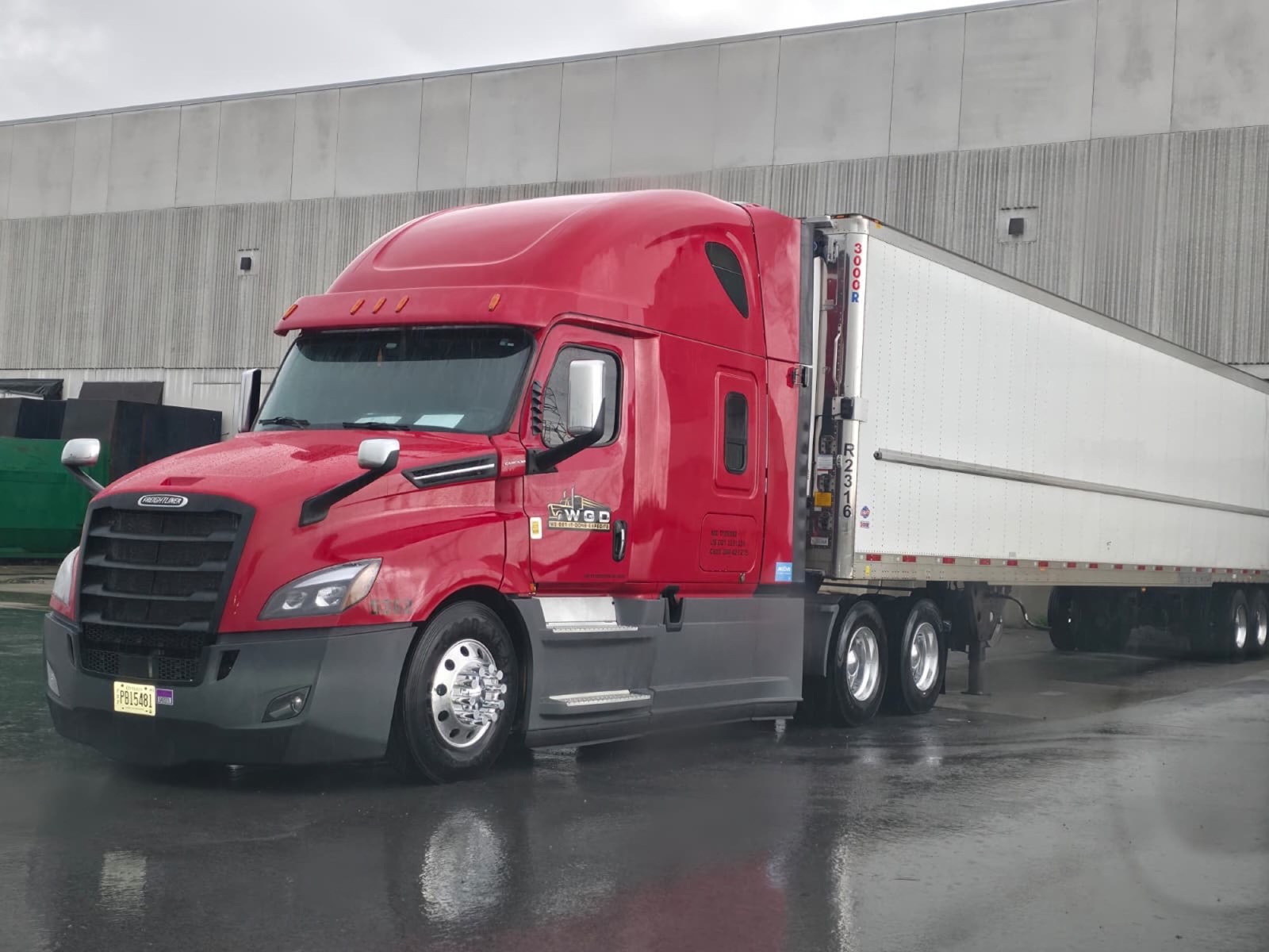 WGD Expedite red Freightliner Cascadia with reefer trailer at warehouse